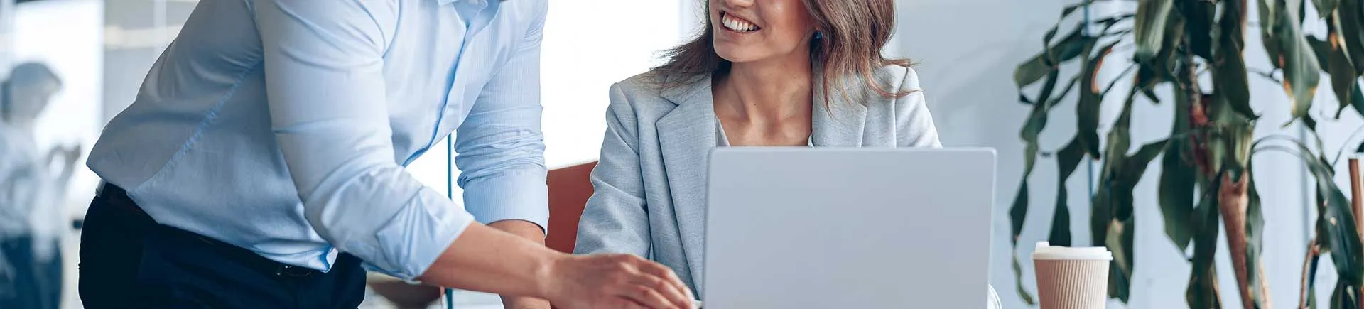 PC technician assisting a woman with her computer in her office